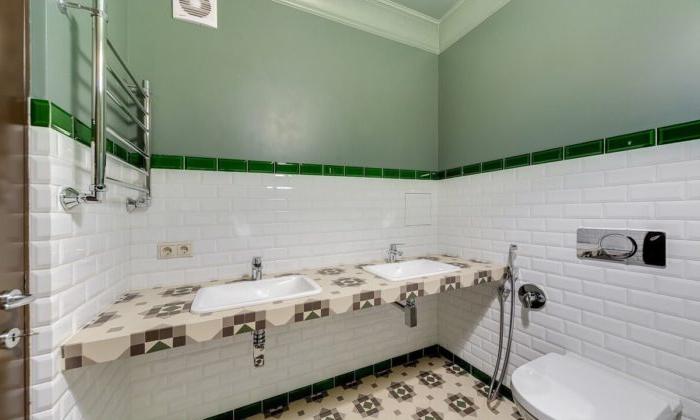Piastrelle bianche al centro del muro e vernice verde in bagno