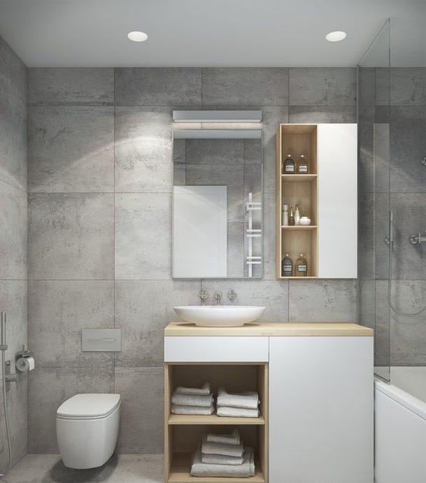 La combinazione di bianco, grigio e legno nel bagno del loft
